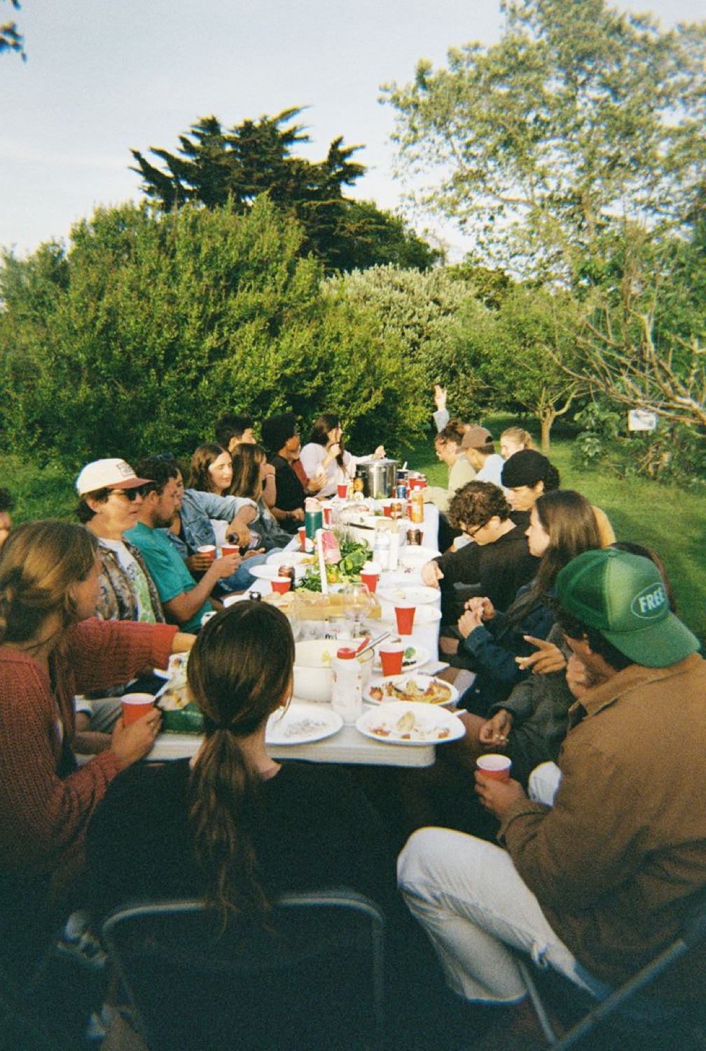 Rhema community gathered around a long table outdoors after a run